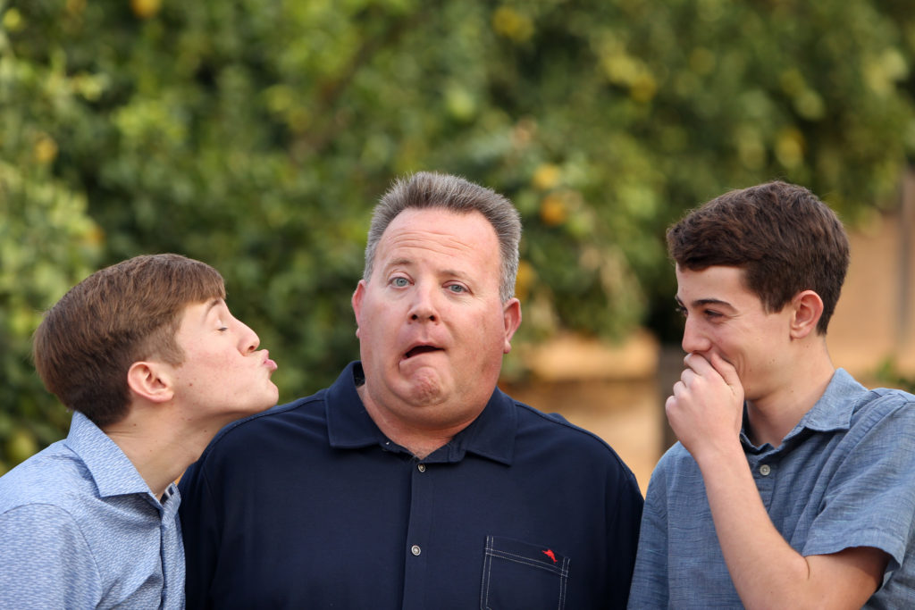 father and sons goofing around