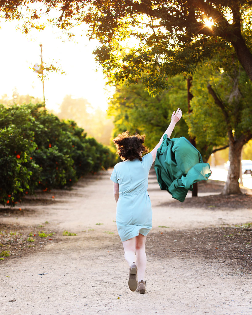 girl running with cap and gown