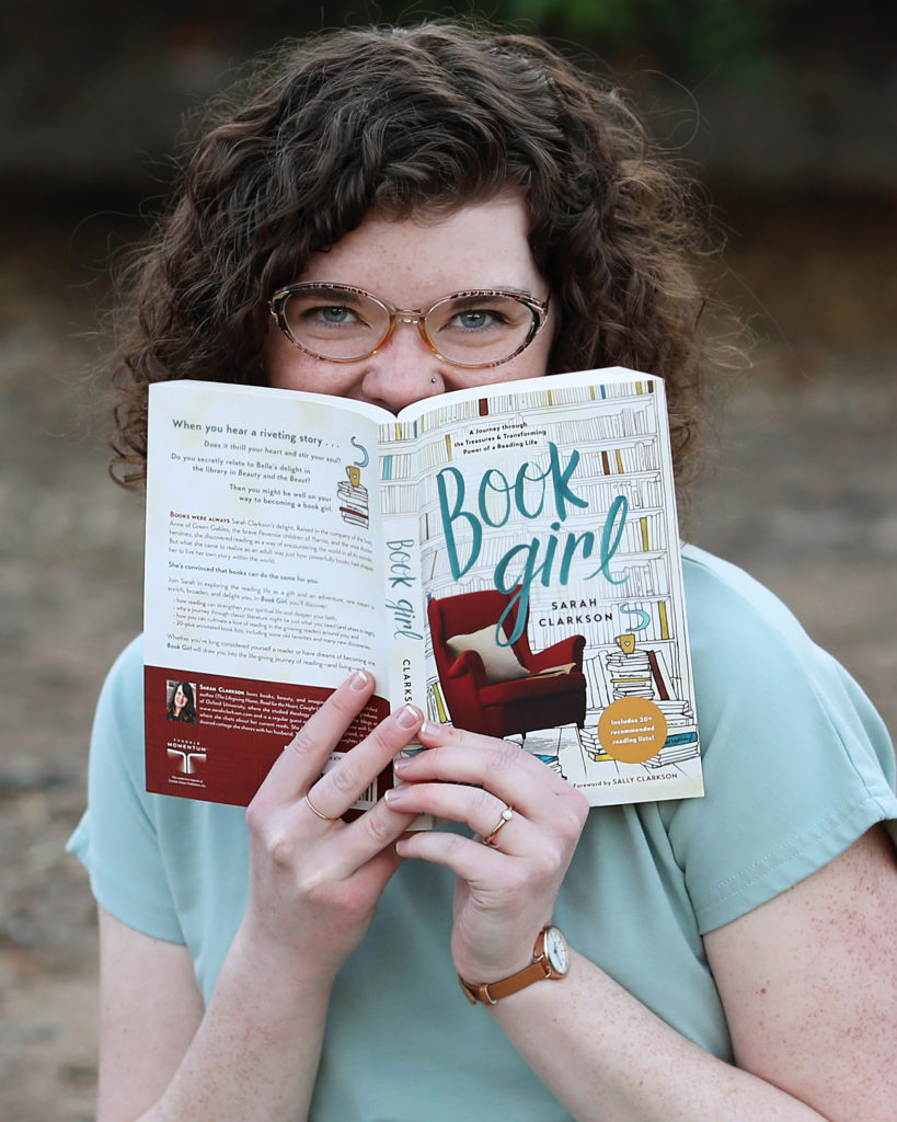 teen girl with book and glasses