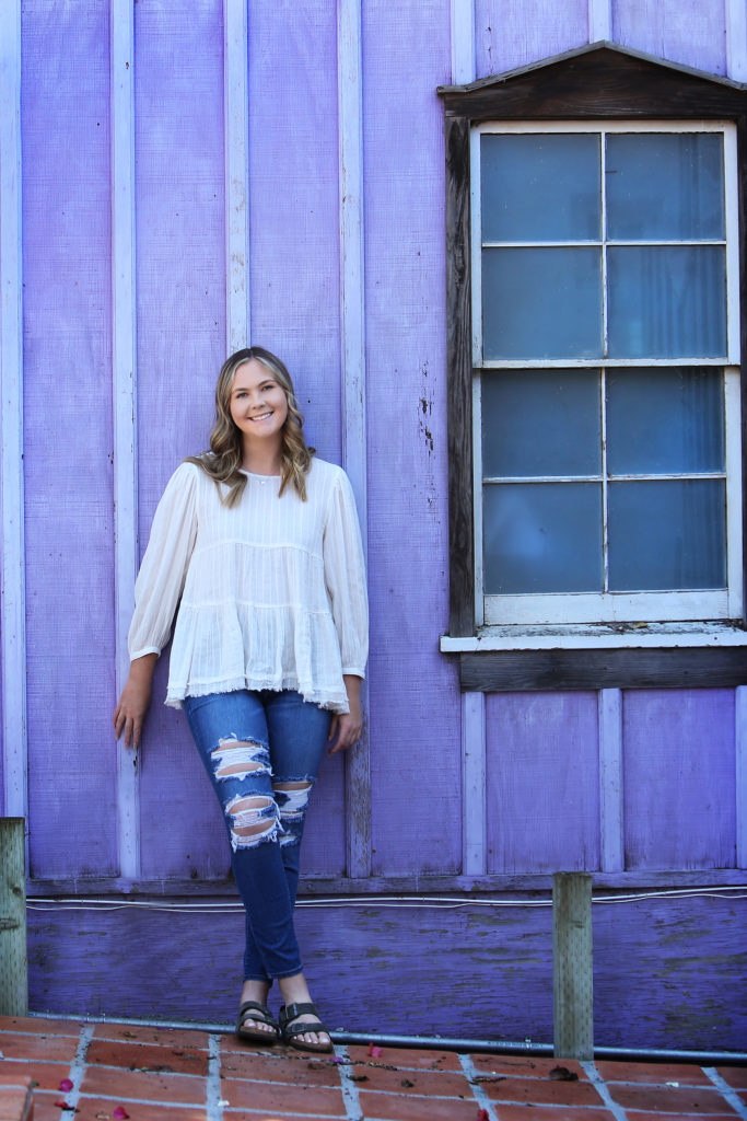 senior photo by lavender wall
