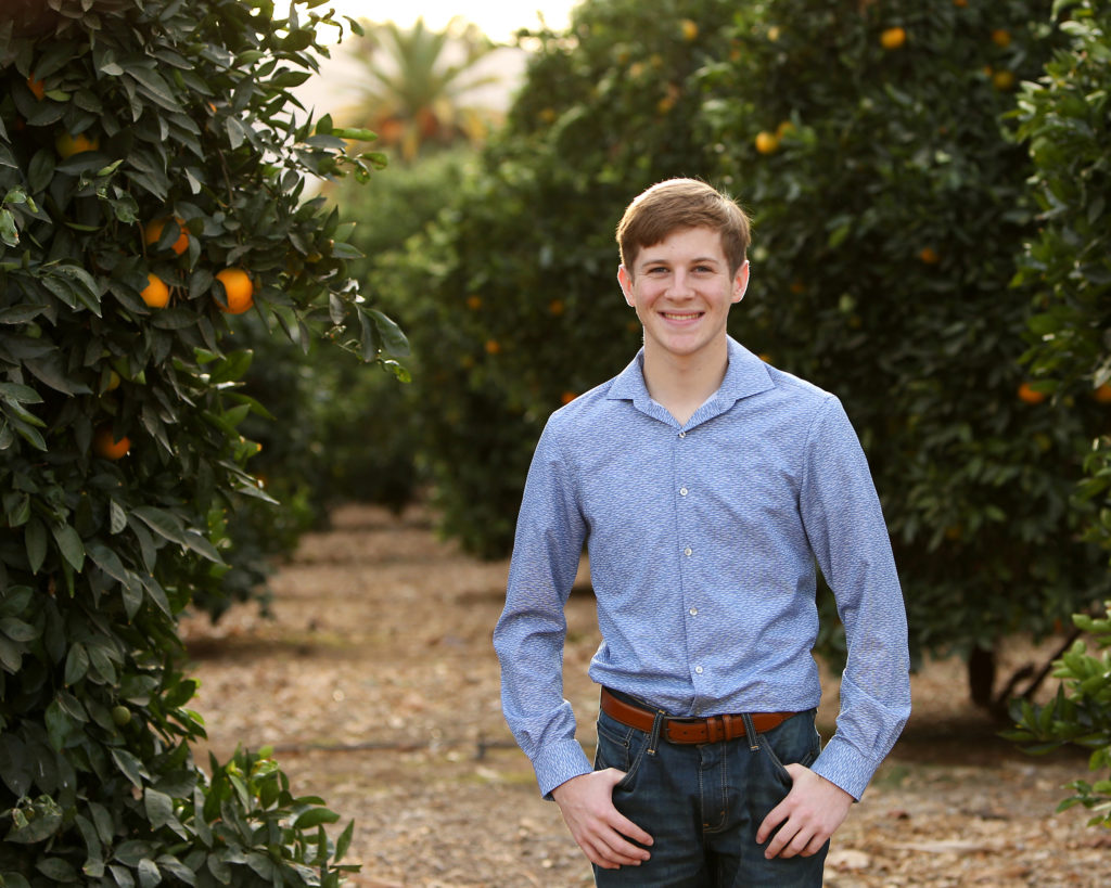 teen guy in orange groves